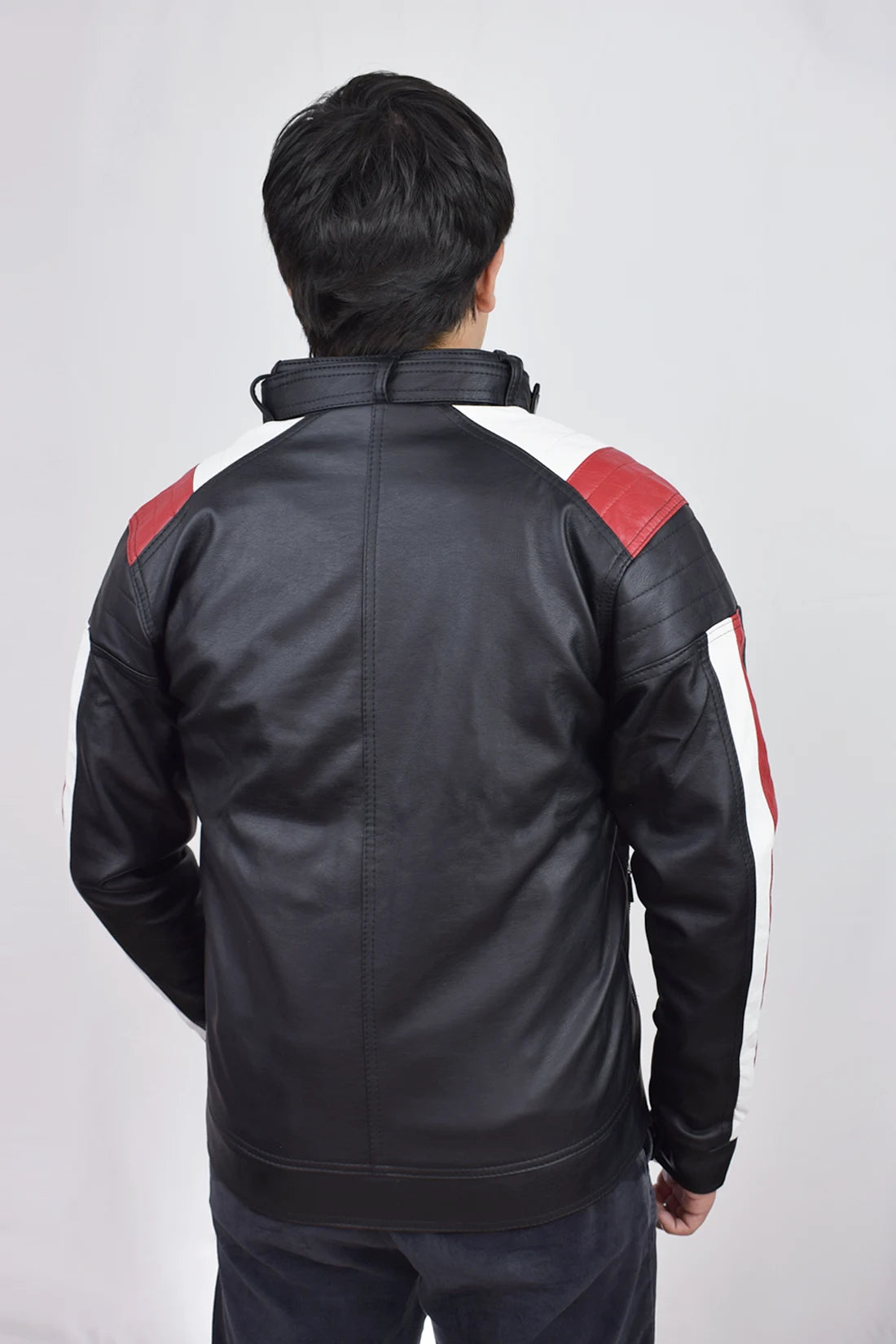 Hombre usando Chaqueta de Cuerotex negra y rayas rojas y blancas, con un diseño minimalista y de corte moderno, modelo AD22, vista espalda.
