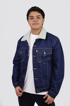 Hombre vistiendo una chaqueta de jean azul industrial con ovejero, mostrando un look vintage y relajado.