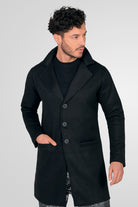 Hombre vistiendo un gabán moderno modelo Oriente en color negro, con corte largo y elegante, vista frontal.